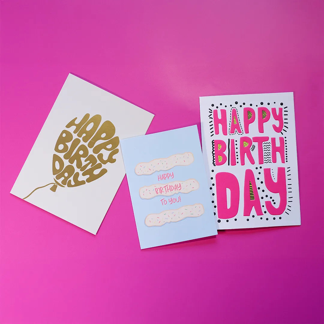 Three 'Happy Birthday' cards on a pink background