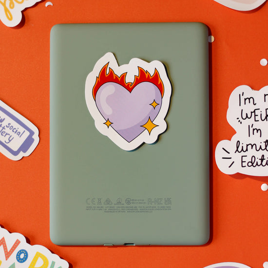 'Purple Heart on Fire' Sticker on an orange background