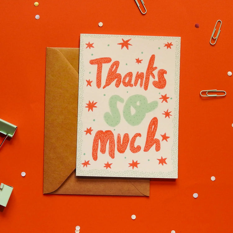 A white greeting card with 'Thanks so much' text, with a brown envelope on an orange background with decorative elements.