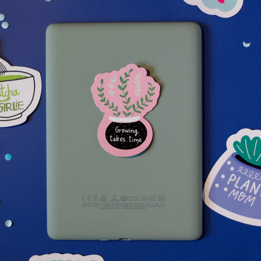 Our 'Growing takes time' sticker on a dark blue background.