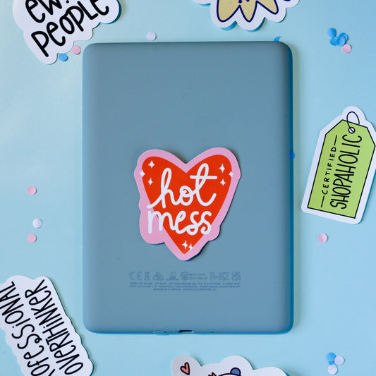 Our 'Hot Mess' a heart-shaped sticker on a blue background.