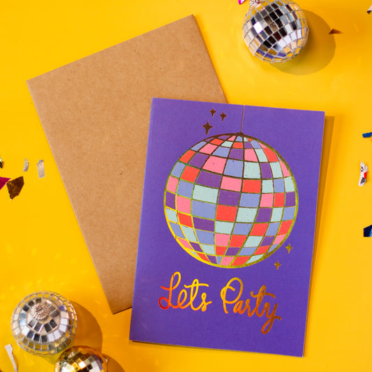 Purple card with disco ball design and 'Let's Party' text with a brown envelope on a yellow background with decorative elements.