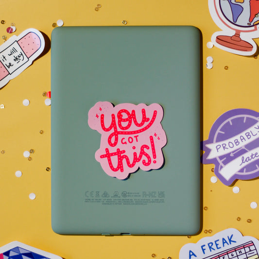 A pink 'You got this!' sticker on a yellow background.