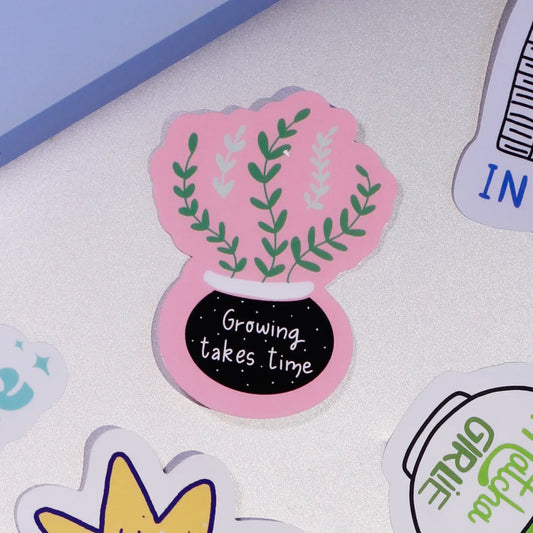 A close-up of our adirable plant design with 'Growing takes time' text on a laptop.