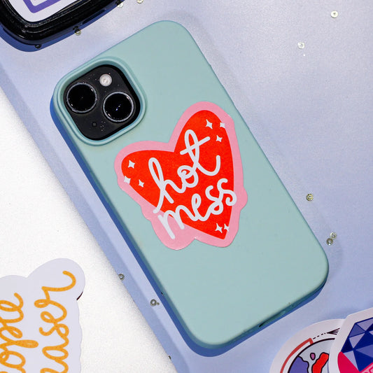 A phone case with our cheeky 'Hot Mess' sticker on a light blue background.